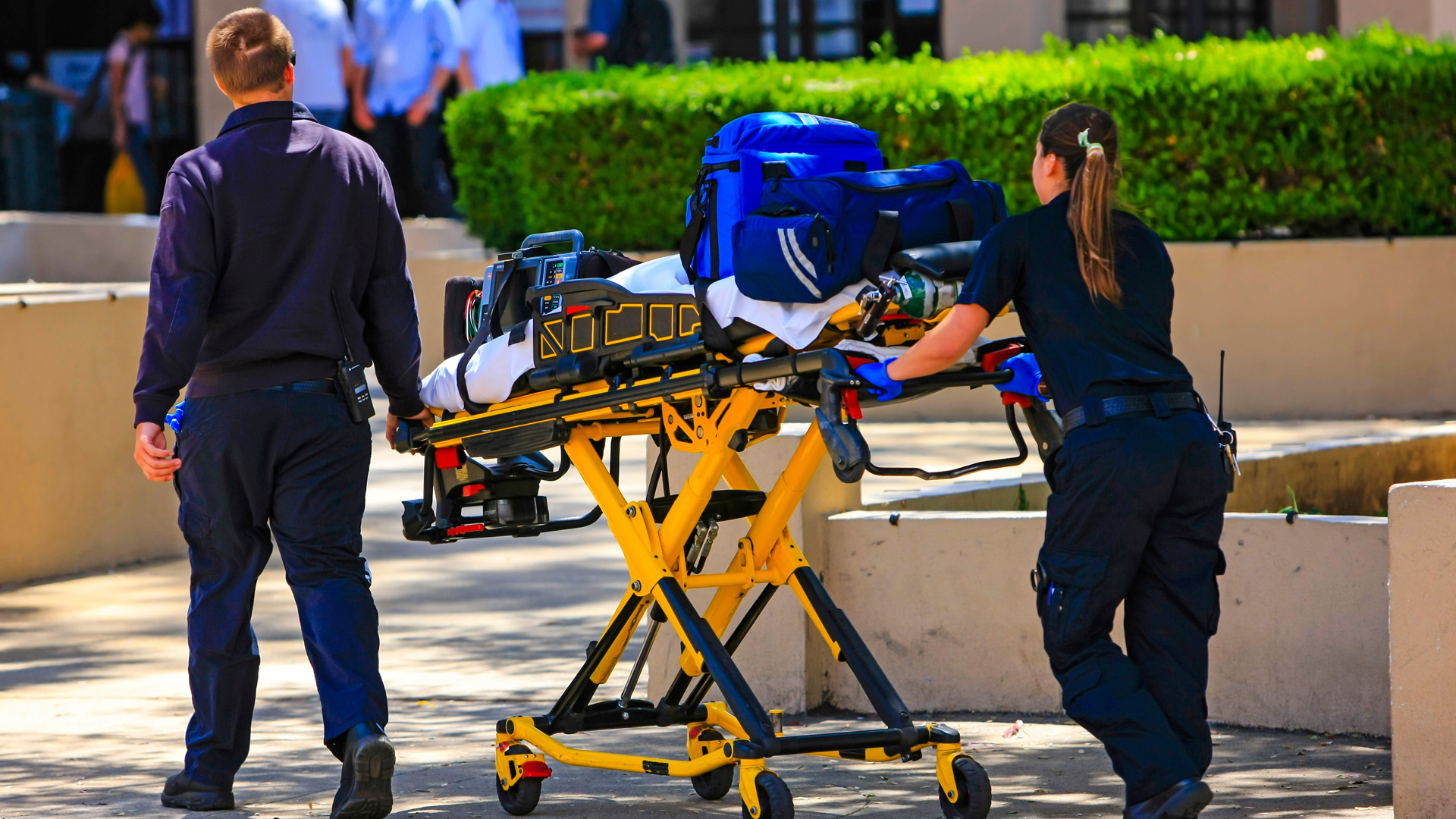 two Advanced EMT arriving on scene with equipment