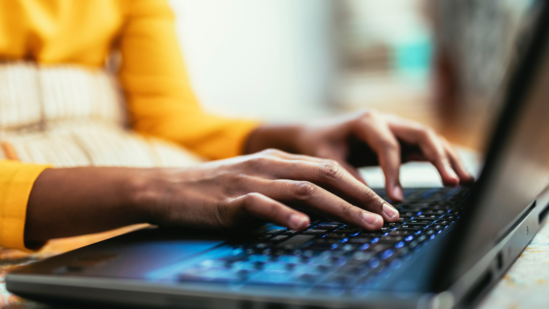 Close up hands typing using laptop computer