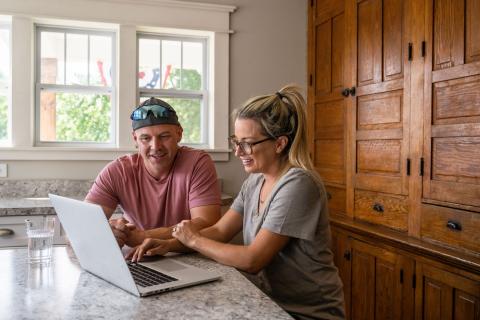 Veteran looking at a computer in a kitchen