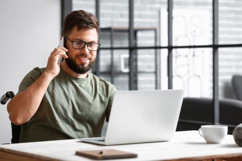 Veteran at a desk talking on the phone