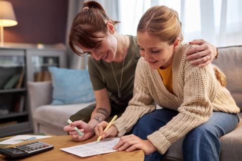 mom and daughter using calculator