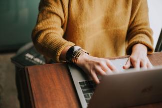 girl typing on a laptop