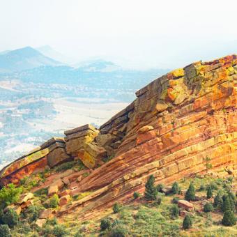 photo of red rocks and mountains in the back