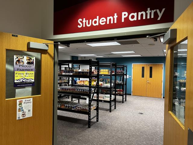 Image shows open doors to the Student Pantry with shelves of food inside.