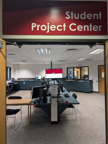 image shows to the Student Project Center with computer workstations inside the room